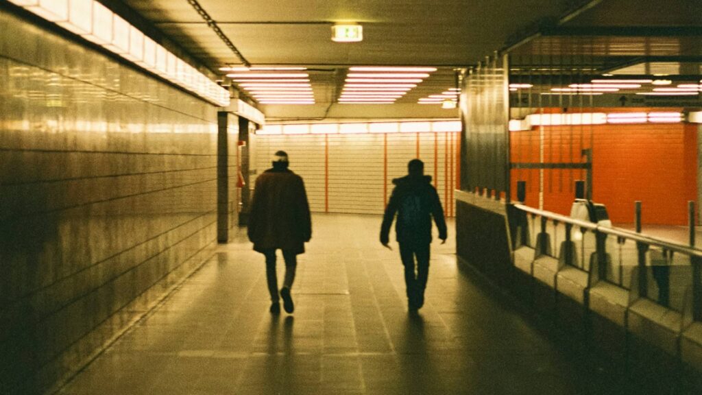 Men walking out of tube station.